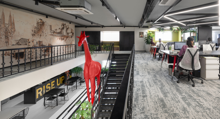 An office interior featuring a giraffe mural on the wall, adding a whimsical touch to the professional environment.
