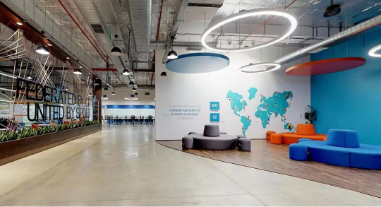 A spacious office featuring vibrant furniture, showcasing 2020 design trends by Centrix in an open layout.