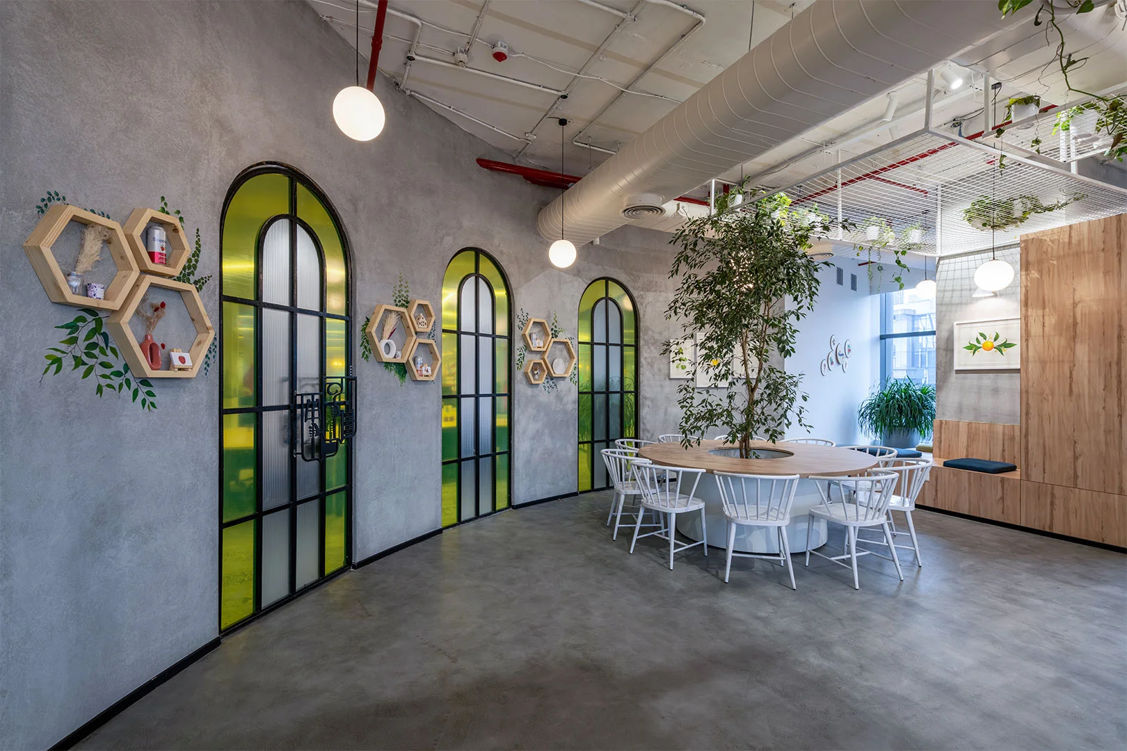 A spacious office featuring a large table surrounded by several chairs, designed for meetings and collaboration.